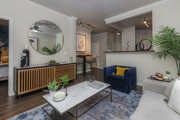 Irving apartment for rent - A living room with a blue couch and a wooden radiator.