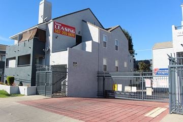 Paramount apartment for rent - a building with a gate and a sign on the side of it