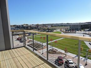 Oak Creek apartment for rent - a balcony with a view of a park and a parking lot