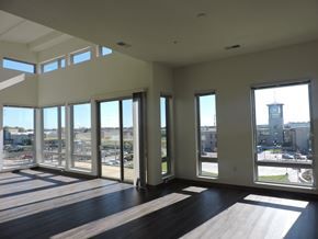 Oak Creek apartment for rent - a living room with large windows and a view of a city