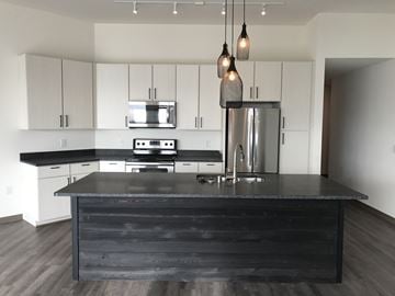 Oak Creek apartment for rent - a kitchen with white cabinets and a black counter top