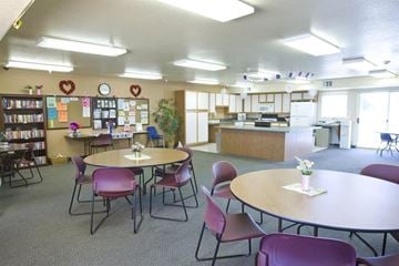 Las Vegas apartment for rent - a room with tables and chairs and a kitchen