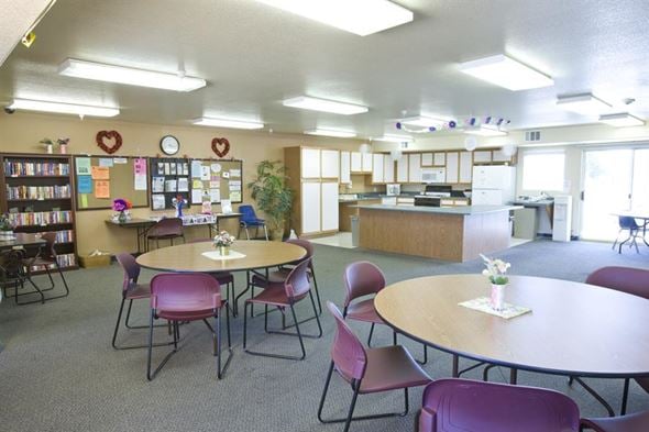 Las Vegas apartment for rent - a room with tables and chairs and a kitchen