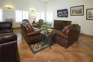 Las Vegas apartment for rent - a living room with leather chairs and a table