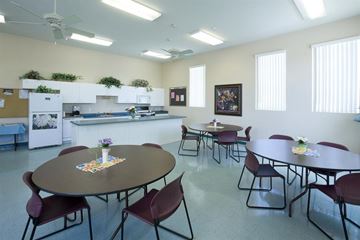 Las Vegas apartment for rent - a multipurpose room with tables and chairs and a kitchen