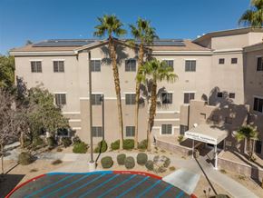 Las Vegas apartment for rent - an overhead view of a building with palm trees and a basketball court