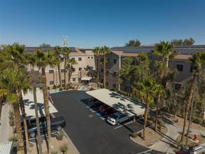 Las Vegas apartment for rent - an aerial view of a parking lot with palm trees and buildings