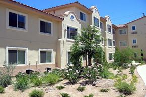 Las Vegas apartment for rent - a row of houses with a garden in front of them