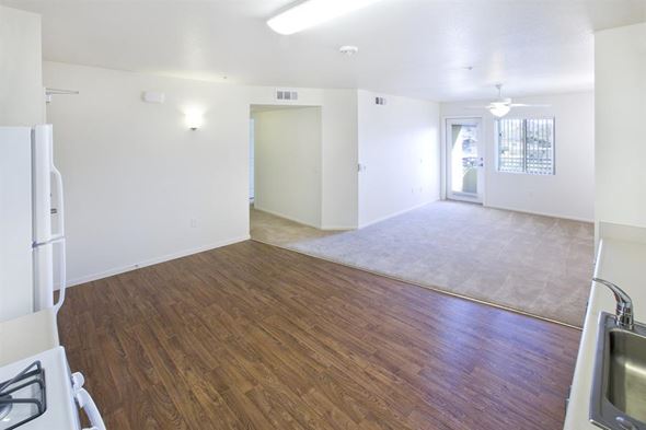 Henderson apartment for rent - an empty living room and kitchen with a wood floor