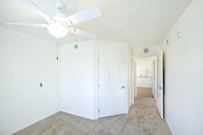 Henderson apartment for rent - an empty room with a ceiling fan and a white door