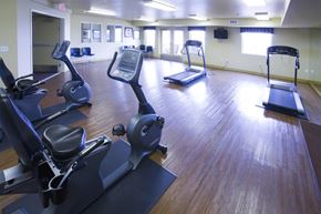 Las Vegas apartment for rent - a gym with various exercise equipment on a wooden floor