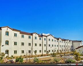 Las Vegas apartment for rent - a row of apartment buildings in front of a blue sky