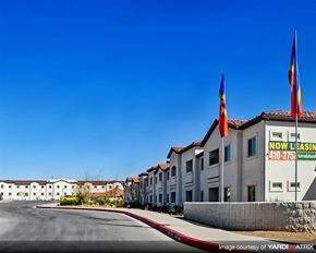 Las Vegas apartment for rent - a row of buildings with flags and a street