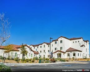 Las Vegas apartment for rent - a group of white buildings on the side of a street