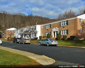 Suffern apartment for rent - A street view of a residential area with cars parked on the side of the road.
