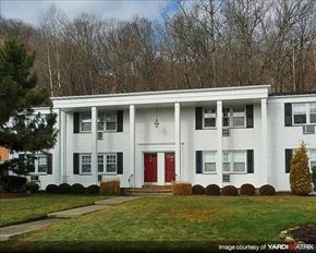 Suffern apartment for rent - A white two story house with a red door and windows.