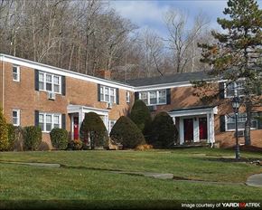 Suffern apartment for rent - A brick house with a red door and white trim.