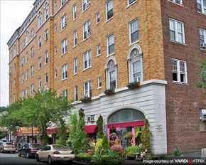 Montclair apartment for rent - A red brick building with a white awning and a tree in front of it.