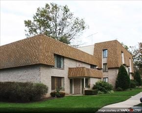 Dublin apartment for rent - A house with a brown roof and a green lawn in front.