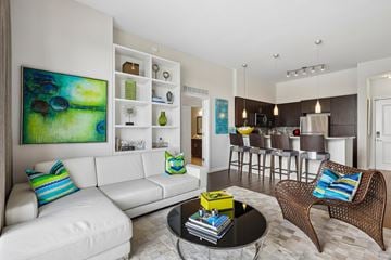 Coral Gables apartment for rent - A living room with a white couch and a painting on the wall.