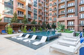 Dallas apartment for rent - a swimming pool in front of an apartment building