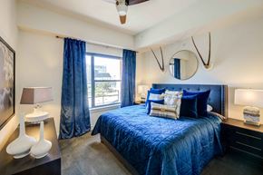 Dallas apartment for rent - a bedroom with a large bed and a window