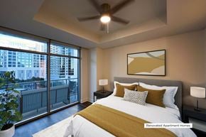 Dallas apartment for rent - A bedroom with a large bed and a ceiling fan.