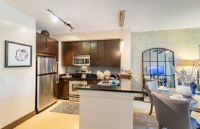 Washington apartment for rent - a kitchen with stainless steel appliances and a dining room table
