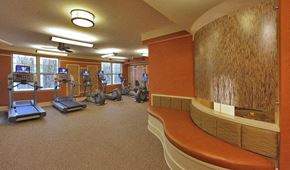 Washington apartment for rent - a gym with exercise equipment and a bench