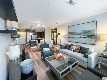 Fairfax apartment for rent - A modern living room with a grey couch and a painting on the wall.