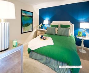 Atlanta apartment for rent - A bedroom with a green bed and a painting on the wall.