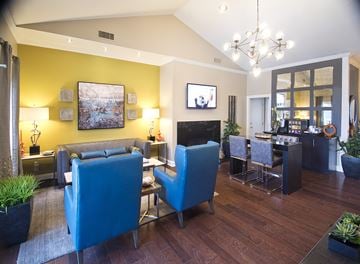 Atlanta apartment for rent - a living room with blue couches and chairs and a dining room with a table