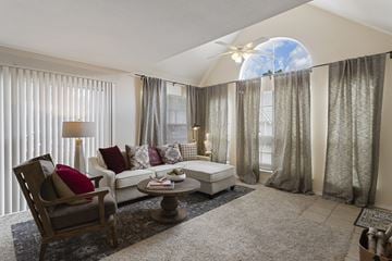 Houston apartment for rent - a living room with a couch and chairs and large windows