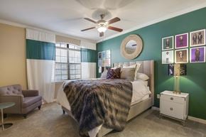 Dallas apartment for rent - a bedroom with a bed and a ceiling fan