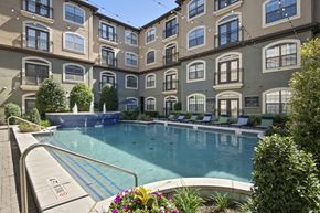 Dallas apartment for rent - a swimming pool in front of an apartment building