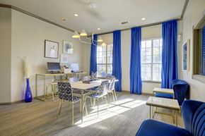 Austin apartment for rent - a dining room with a table and chairs and a desk with a laptop