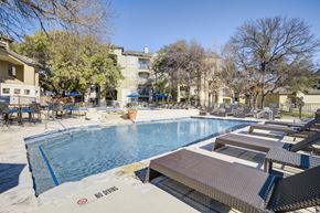 Austin apartment for rent - a swimming pool with tables and chairs around it