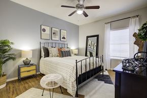 Austin apartment for rent - a bedroom with a bed and a ceiling fan