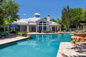 Austin apartment for rent - A large house with a pool in front.