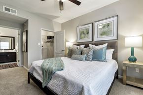Austin apartment for rent - a bedroom with a large bed and a ceiling fan