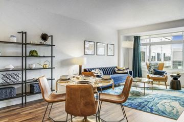 Cambridge apartment for rent - a living room with a couch and a table with chairs