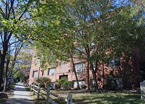 Washington apartment for rent - a brick building with trees in front of it and a sidewalk