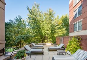 Washington apartment for rent - a patio with couches and chairs and trees in the background