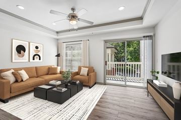 Dunwoody apartment for rent - A modern living room with a brown sofa, a black coffee table, and a ceiling fan.