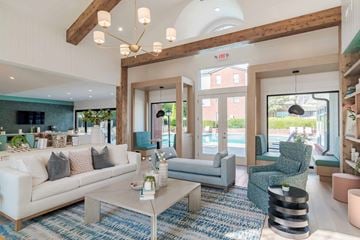 Dunwoody apartment for rent - A modern living room with a white sofa and a coffee table.