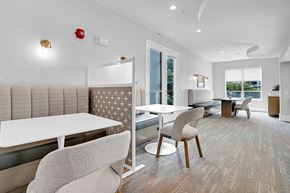 Dallas apartment for rent - A modern dining room with a white table and chairs.