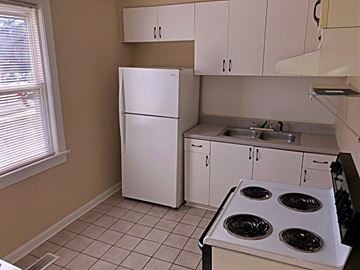 Raleigh apartment for rent - a kitchen with a stove and a refrigerator