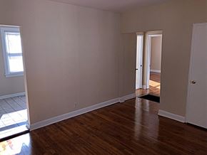 Raleigh apartment for rent - a living room with wooden floors and a door to a hallway
