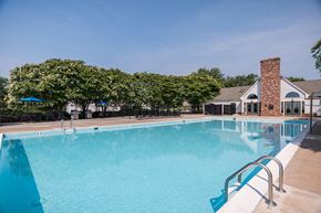 Woodbridge apartment for rent - a swimming pool with a house in the background