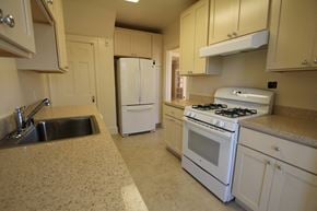 San Francisco triplex for rent - a kitchen with white appliances and white cabinets